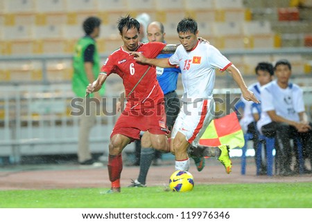 BANGKOK THAILAND-NOV 24:Truong DÃ?Â¬nh Luat of Vietnam (white) in action during the AFF Suzuki Cup between Vietnam and Myanmar at Rajamangala stadium on Nov24, 2012 in Bangkok,Thailand.