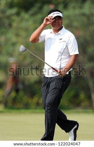 CHONBURI,THAILAND-DECEMBER 6:Mardan Mamat of Singapore gestures to his fans during hole 2 day one of the Thailand Golf Championship at Amata Spring Country Club on Dec 6,2012 in,Thailand.