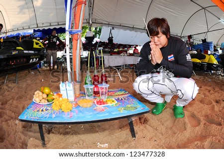 PATTAYA THAILAND-DECEMBER 8:Supak Settura of Thailand athletes are offering sacrifices to a holy spirit before the Jetski  King's Cup World Cup Grand Prix at Jomtien Beach on Dec8,2012in,Thailand.