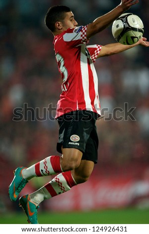 BANGKOK,THAILAND-JANUARY 8: Zakaria Bakkali (RED) of PSV in action during The AIA Champions Cup match between SCG Muangthong Utd. and PSV at SCG Stadium on Jan8 ,2012 in ,Thailand.