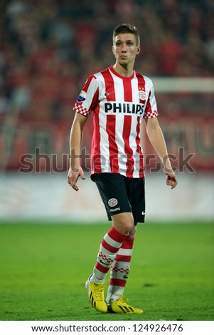 BANGKOK,THAILAND-JANUARY 8: 	Peter van Ooijen (RED) of PSV in action during The AIA Champions Cup match between SCG Muangthong Utd. and PSV at SCG Stadium on Jan8 ,2012 in ,Thailand.