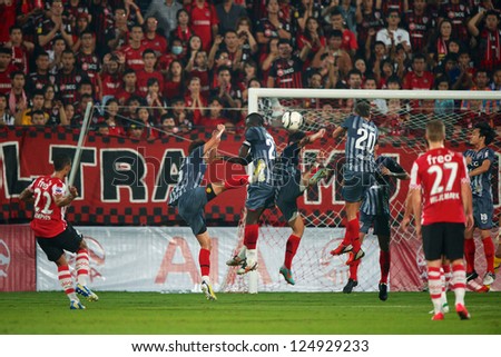 BANGKOK,THAILAND-JANUARY 8: Memphis Depay (L) of PSV in action during The AIA Champions Cup match between SCG Muangthong Utd. and PSV at SCG Stadium on Jan8 ,2012 in ,Thailand.