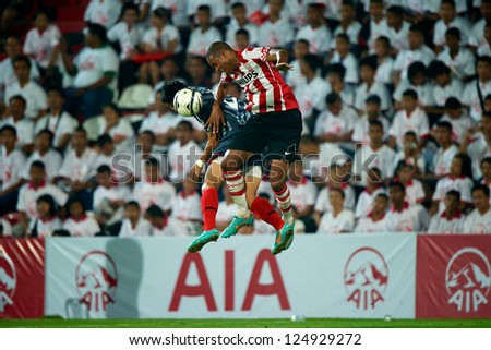 BANGKOK,THAILAND-JANUARY 8: Mathias Jrgensen (red) of PSV in action during The AIA Champions Cup match between SCG Muangthong Utd. and PSV at SCG Stadium on Jan8 ,2012 in ,Thailand.
