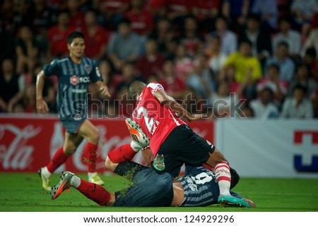 BANGKOK,THAILAND-JANUARY 8: Mathias Jrgensen (red) of PSV in action during The AIA Champions Cup match between SCG Muangthong Utd. and PSV at SCG Stadium on Jan8 ,2012 in ,Thailand.