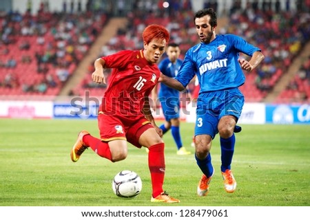 BANGKOK THAILAND-FEBRUARY 06:Jakkraphan Pornsai (red)of Thailand  in action during the football 2015 Asian Cup qualifying between Thailand and Kuwait at Rajamangala stadium on Feb 06,2013 in,Thailand.