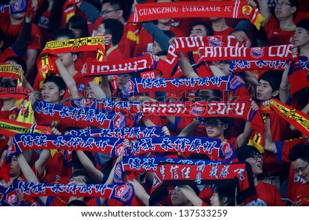 GUANGZHOU,CHINA-APRIL 03: Unidentified of Guangzhou Evergrande show scarf supporters during the AFC Champions League between Guangzhou Evergrande and MTUTD at Tianhe Stadium on April 3, 2013in,China.