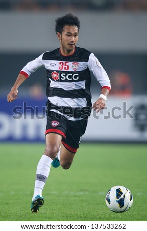 GUANGZHOU,CHINA-APRIL 03:Weerawut Kayem of Muangthong Utd.run with the ball during the AFC Champions League between Guangzhou Evergrande and Muangthong Utd. at Tianhe Stadium on April 3,2013 in,China.