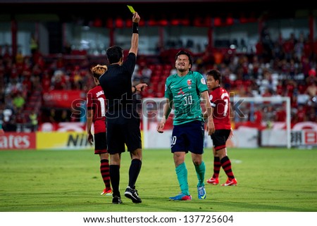 NONTHABURI,THAILAND-MAY 01:Shinzo Koroki #30 (R) of Urawa Red Diamonds control the ball during the AFC Champions League between Muangthong Utd.and Urawa Red Diamonds on May 1,2013 in,Thailand.