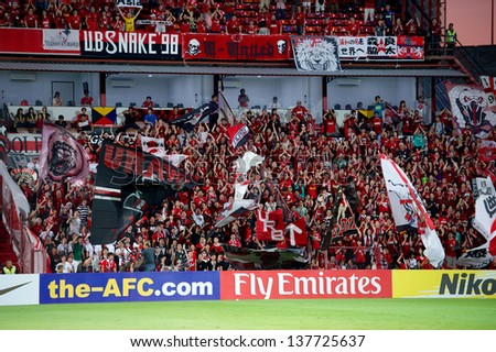 NONTHABURI,THAILAND-MAY 01:Unidentified of Urawa Red Diamonds Flag supporters during the AFC Champions League between Muangthong Utd.and Urawa Red Diamonds at SCG Stadium on May 1,2013 in,Thailand.