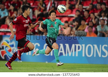 NONTHABURI,THAILAND-MAY 01:Tomoya Ugajin (R) of Urawa Red Diamonds in action during the AFC Champions League between Muangthong Utd.and Urawa Red Diamonds at SCG stadium on May 1,2013 in,Thailand.