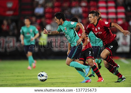 NONTHABURI,THAILAND-MAY 01:Shinzo Koroki #30 (L) of Urawa Red Diamonds control the ball during the AFC Champions League between Muangthong Utd.and Urawa Red Diamonds on May 1,2013 in,Thailand.