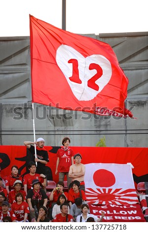 NONTHABURI,THAILAND-MAY 01:Unidentified fans of Urawa Red Diamonds Flag supporters during theAFC Champions League between Muangthong Utd.and Urawa Red Diamonds at SCG Stadium on May1,2013 in,Thailand.