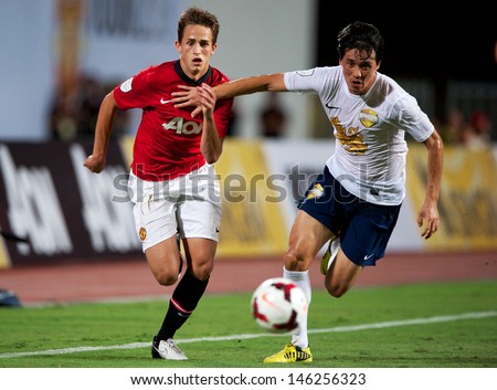 BANGKOK,THAILAND-JULY13: Adnan Januzaj (L)of Manchester United in action during the friendly match between Singha All Star XI and Manchester United at Rajamangala Stadium on July 13, 2013 in Thailand.