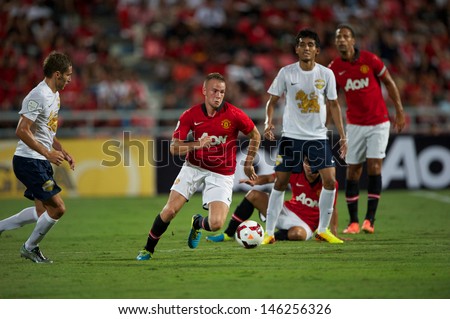 BANGKOK THAILAND-JULY13: Tom Cleverly (L2) of Manchester United in action during the friendly match between Singha All Star XI and Manchester United at Rajamangala Stadium on July13,2013 in Thailand.