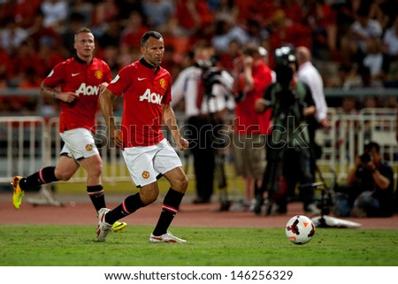 BANGKOK,THAILAND-JULY13: Ryan Giggs (L2) of Manchester United in action during the friendly match between Singha All Star XI and Manchester United at Rajamangala Stadium on July 13, 2013 in Thailand.