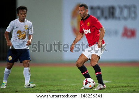 BANGKOK,THAILAND-JULY13: Ryan Giggs (R) of Manchester United in action during the friendly match between Singha All Star XI and Manchester United at Rajamangala Stadium on July 13, 2013 in Thailand.