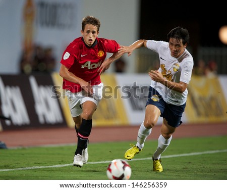 BANGKOK,THAILAND-JULY13:Ri Kwang Chon (R)of Singha All Star XI in action during the friendly match between Singha All Star XI and Manchester United at Rajamangala Stadium on July13, 2013 in Thailand.