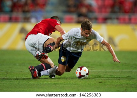 BANGKOK,THAILAND-JULY13:Mario Djurovski(R)of Singha All Star XI in action during the friendly match between Singha All Star XI and Manchester United at Rajamangala Stadium on July13, 2013 in Thailand.