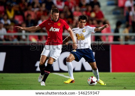 BANGKOK THAILAND-JULY13:Michael Carrick (L)of Manchester United in action during the friendly match between Singha All Star XI and Manchester United at Rajamangala Stadium on July13,2013 in Thailand.