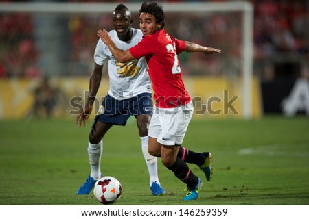 BANGKOK THAILAND-JULY13:Fabio (R) of Manchester United in action during the friendly match between Singha All Star XI and Manchester United at Rajamangala Stadium on July13,2013 in Thailand.