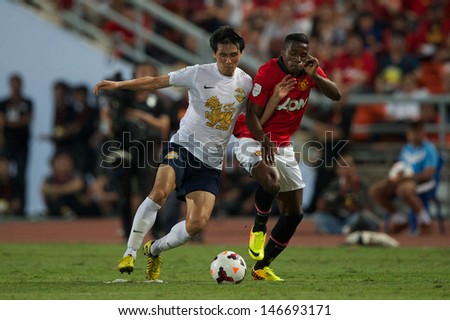 BANGKOK,THAILAND-JULY13: Wilfried Zaha (R) of Manchester United in action during the friendly match between Singha All Star and Manchester United at Rajamangala Stadium on July 13, 2013 in Thailand.