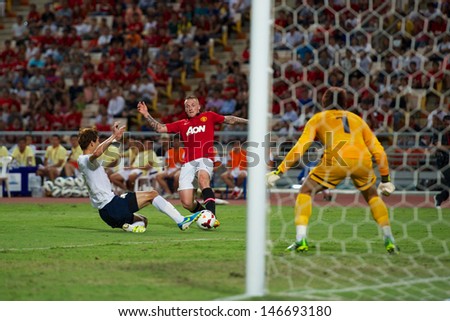 BANGKOK,THAILAND-JULY13: Tom Cleverley (C) of Manchester United in action during the friendly match between Singha All Star and Manchester United at Rajamangala Stadium on July 13, 2013 in Thailand.