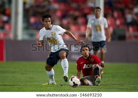 BANGKOK,THAILAND-JULY13:Chatree Chimtalay (L) of Singha All Star  in action during the friendly match between Singha All Star and Manchester United at Rajamangala Stadium on July13, 2013 in Thailand.