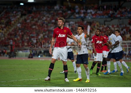 BANGKOK,THAILAND-JULY13: Michael Carrick (L)of Manchester United in action during the friendly match between Singha All Star and Manchester United at Rajamangala Stadium on July 13, 2013 in Thailand.