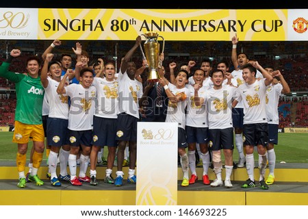 BANGKOK,THAILAND-JULY13:Singha All Star Team celebrate with the trophy after the friendly match between Singha All Star XI and Manchester United at Rajamangala Stadium on July13, 2013 in Thailand.