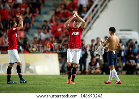 BANGKOK,THAILAND-JULY13: Michael Carrick (C)of Manchester United in action during the friendly match between Singha All Star and Manchester United at Rajamangala Stadium on July 13, 2013 in Thailand.