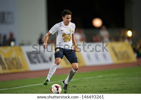 BANGKOK,THAILAND-JULY13:	Thitipan Puangchan of Singha All Star  in action during the friendly match between Singha All Star and Manchester United at Rajamangala Stadium on July13, 2013 in Thailand.