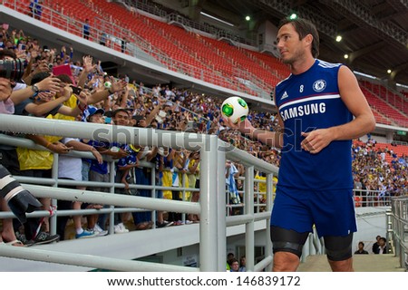BANGKOK,THAILAND-JULY 16: Frank Lampard of Chelsea FC throws footballs to fans during a Chelsea FC training session at Rajamangala Stadium on July 16, 2013 in Bangkok, Thailand.