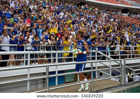 BANGKOK,THAILAND-JULY 16:Ashley Cole of Chelsea FC throws footballs to fans during a Chelsea FC training session at Rajamangala Stadium on July 16, 2013 in Bangkok, Thailand.
