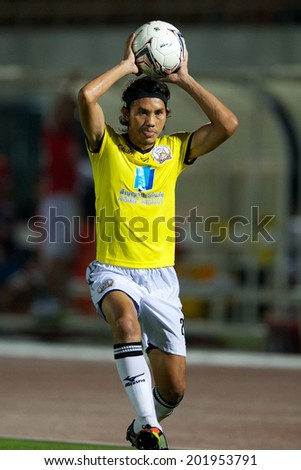 BANGKOK THAILAND-APRIL 05:	Adul Muensaman (yellow) of Police United  in action during Thai Premier League Bangkok United and Police United at Thai-Japanese Stadiumon Apr 05,2014 in Thailand