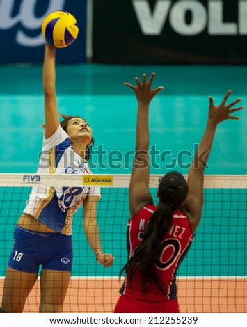 BANGKOK,THAILAND-AU GUST15:Ajcharaporn	 Kongyot (L)of Thailand spikes the ball during the FIVB World Grand Prix Thailand and Dominican Republic at Indoor Stadium Huamark on Aug.15, 2014 in Thailand.