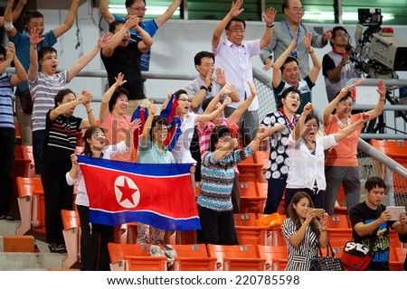 NONTHABURI THAILAND-SEPTEMBER 17:Unidentified fans of DPR Korea supporters during the AFC U-16 Championship between Australia and DPR Korea at Rajamangala Stadium on Sep17,2014,Thailand