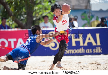 PHUKET,THAILAND-NOVEMBER 13:Suzuki Keita no.39 of Japan runs with the football during Beach Flag Football Thailand and Japan during the 2014 Asian Beach Games at Saphan Hin on Nov 13,2014 in Thailand.