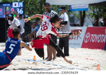 PHUKET,THAILAND-NOVEMBER 13:Suzuki Keita no.39 of Japan runs with the football during Beach Flag Football Thailand and Japan during the 2014 Asian Beach Games at Saphan Hin on Nov 13,2014 in Thailand.