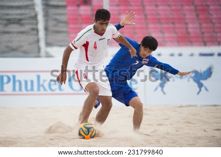 PHUKET THAILAND-NOVEMBER19:Mehdi HassanInoznri (L) of  Iran in action during the Beach Soccer match between Thailand and Iran the 2014 Asian Beach Games at Saphan Hin on Nov 19,2014 in Thailand