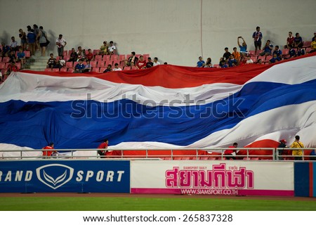 BANGKOK,THAILAND-MARCH 30:Thailand fan shows big flag support the international friendly match between Thailand and Cameroon at Rajamangala Stadium on March30 2015 in,Thailand.