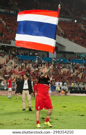 BANGKOK THAILAND JULY14:Alberto Moreno of Liverpool rises the Thailand flag  during the international friendly match Thai All Stars and Liverpool FC at Rajamangala Stadium on July14,2015 in,Thailand.