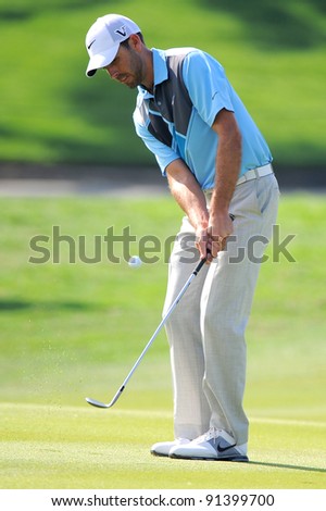 CHONBURI, THAILAND - DECEMBER 15:Charl Schwartzel of South Africa plays a shot during day one of the Thailand Golf Championship at Amata Spring Country Club on December 15, 2011 in Chonburi, Thailand.