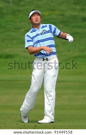 CHONBURI, THAILAND - DECEMBER 15:Daisuke MARUYAMA of Japan plays a shot during day one of the Thailand Golf Championship at Amata Spring Country Club on December 15, 2011 in Chonburi, Thailand.