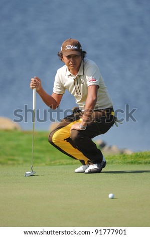 CHONBURI, THAILAND - DECEMBER 15: Hiroshi Iwata of Japan lines up a putt during day one of the Thailand Golf Championship at Amata Spring Country Club on December 15, 2011 in Chonburi, Thailand.