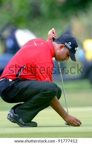 CHONBURI, THAILAND - DECEMBER 15: Jeev Milkha Singh of India lines up a putt during day one of the Thailand Golf Championship at Amata Spring Country Club on December 15, 2011 in Chonburi, Thailand.