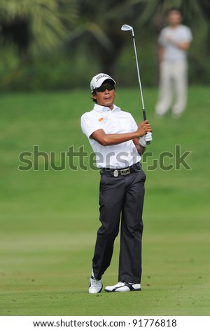 CHONBURI,THAILAND - DECEMBER 15:Juvic PAGUNSAN of the Philippines plays a shot during day one of the Thailand Golf Championship at Amata Spring Country Club on December 15, 2011 in Chonburi, Thailand.