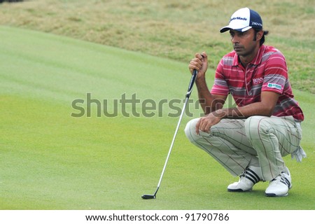 CHONBURI,THAILAND - DECEMBER 15: Jyoti Randhawa of India lines up a putt during day one of the Thailand Golf Championship at Amata Spring Country Club on December 15, 2011 in Chonburi, Thailand.