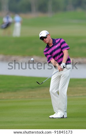 CHONBURI,THAILAND - DECEMBER 15:Simon DYSON of ENGLAND plays a shot during day one of the Thailand Golf Championship at Amata Spring Country Club on December 15, 2011 in Chonburi, Thailand.