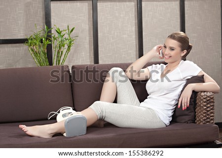 Relaxed young female getting a stone massage in a spa