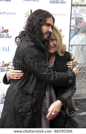 LOS ANGELES, CA - NOVEMBER 06: Russell Brand and his mother arrive at A Day Of Champions Benefiting the Bogart Pediatric Cancer Research Program at Sports Museum of Los Angeles on November 6, 2011.